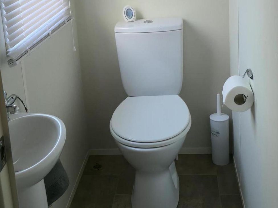 A bathroom with a toilet and sink at Port Haverigg Cabin Sleeps 4 Steel Green near Haverigg