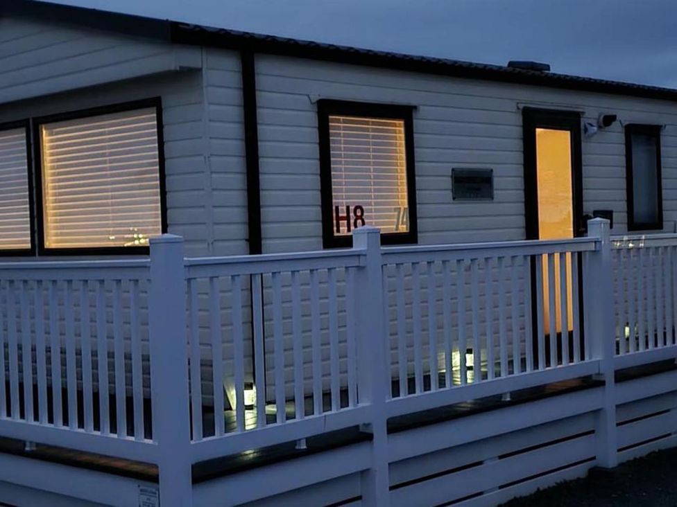 A cabin with lights on inside at Port Haverigg Cabin Sleeps 4 Steel Green near Haverigg