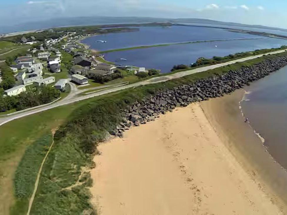 An aerial view of a beach and residential area at Port Haverigg Cabin Sleeps 4 Steel Green near Haverigg