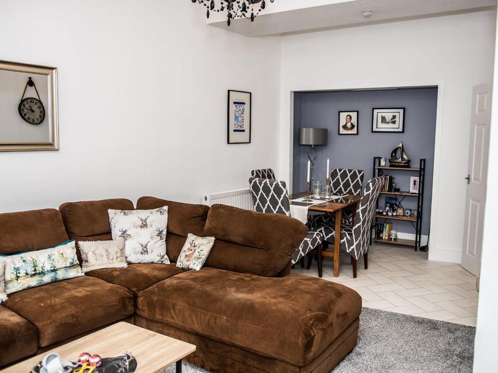 A living room with a sofa and dining area at Rose Apartment 2-Bed Apt, Sleeps 4 Town Centre Ayr