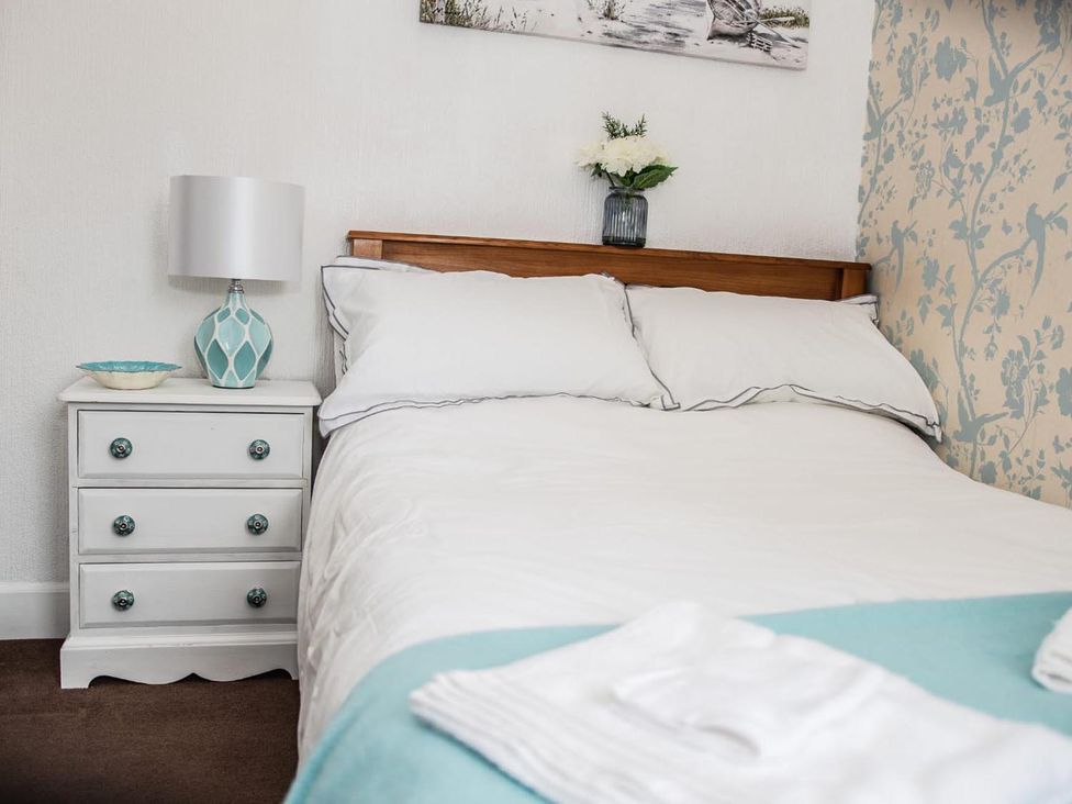 A bedroom with a bed and nightstand at Rose Apartment 2-Bed Apt, Sleeps 4 Town Centre Ayr