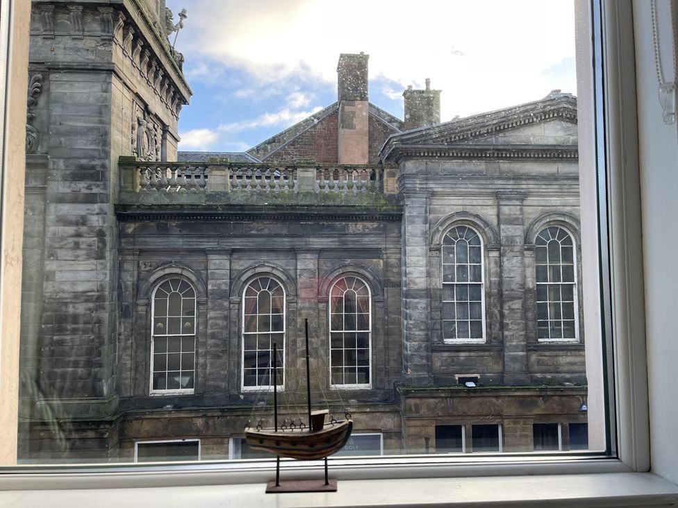 A view from a window featuring a model ship and a building at Rose Apartment 2-Bed Apt, Sleeps 4 Town Centre Ayr