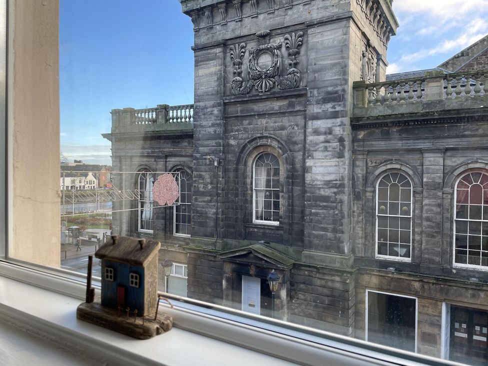 A window with a miniature house overlooking a building at Rose Apartment 2-Bed Apt, Sleeps 4 Town Centre Ayr