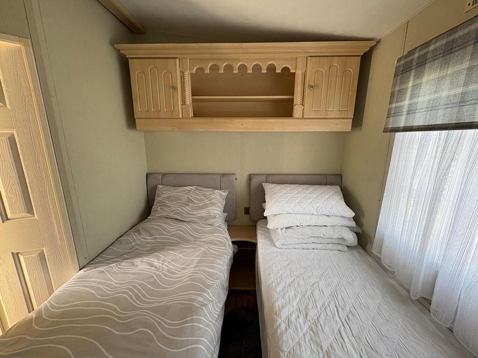 A bedroom with two beds and cabinets at 2 Bed Lodge Sleeps 5 - Pet Friendly, WiFi, Parking, Skegness