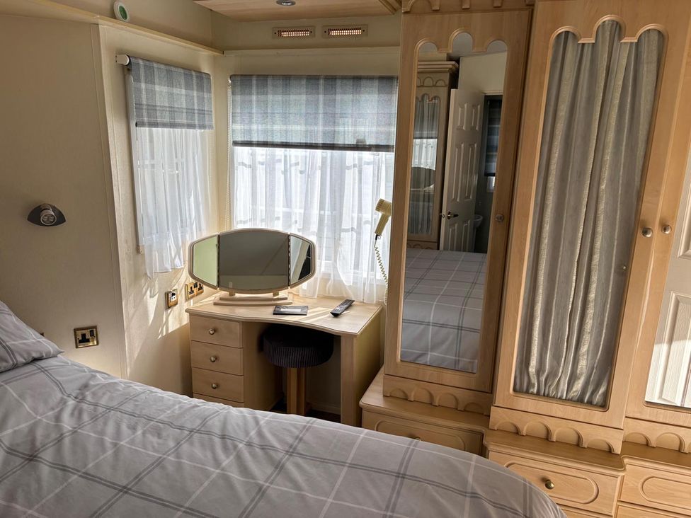 A bedroom with a bed, dresser, and mirror at 2 Bed Lodge Sleeps 5 - Pet Friendly, WiFi, Parking Skegness