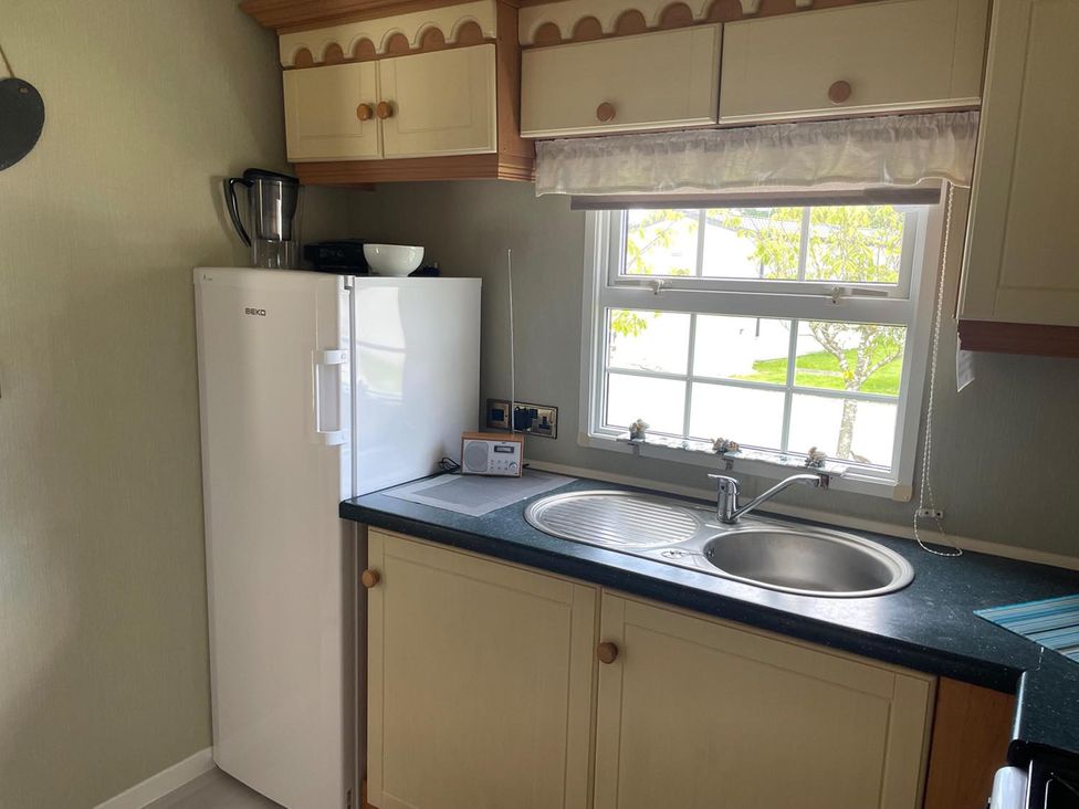A kitchen with a refrigerator and sink at 2 Bed Lodge Sleeps 5 - Pet Friendly, WiFi, Parking Skegness