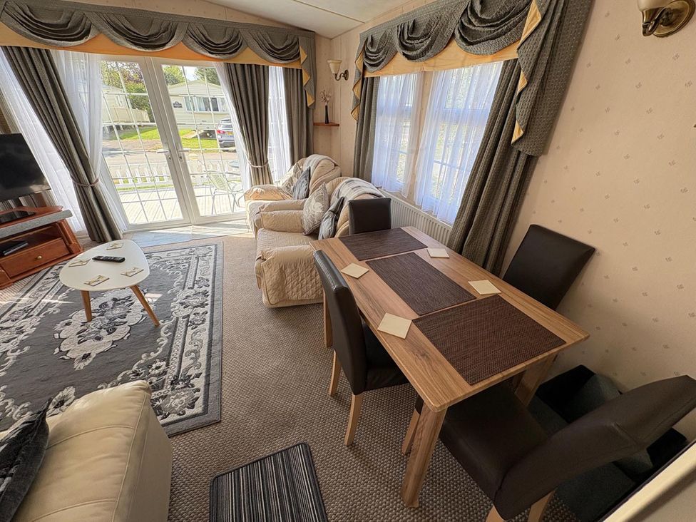 A living room with a dining table and sofa at 2 Bed Lodge Sleeps 5 - Pet Friendly, WiFi, Parking in Skegness