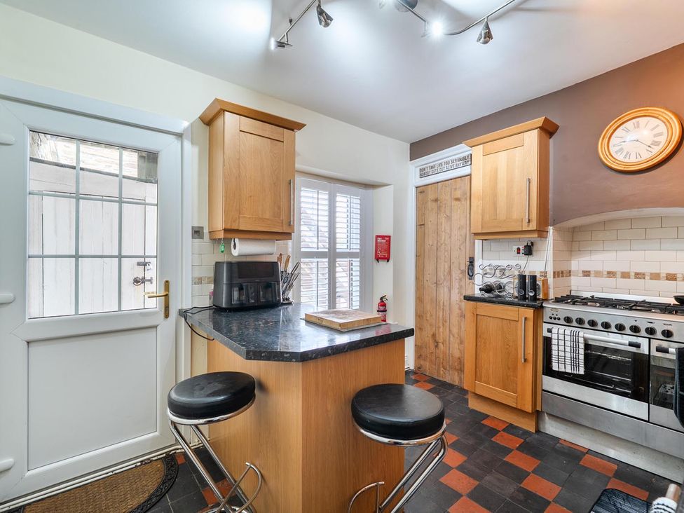 A kitchen with a countertop and bar stools at 1 Bed - Sleeps 4 - Parking - Pets - Town Centre Wadebridge