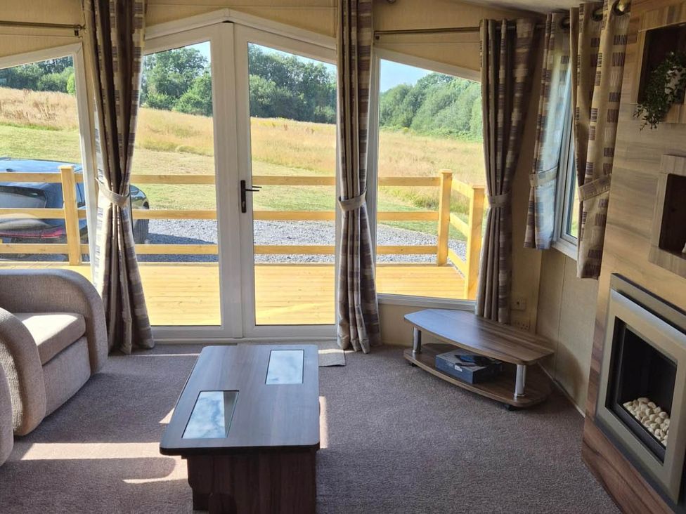 A living room with a sofa and coffee table at Cabin - Sleeps 6 - Outdoor Pool and Parking in Cenarth