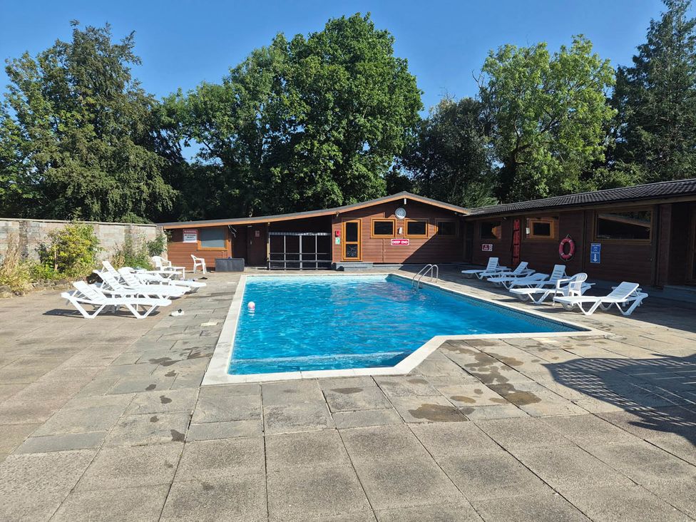 An outdoor pool area with sun loungers at Cabin - Sleeps 6 - Outdoor Pool and Parking in Cenarth