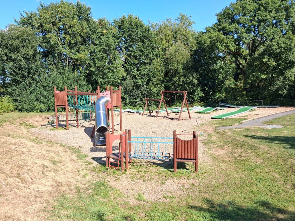 A playground with slide and swings at Cabin - Sleeps 6 - Outdoor Pool and Parking, Cenarth