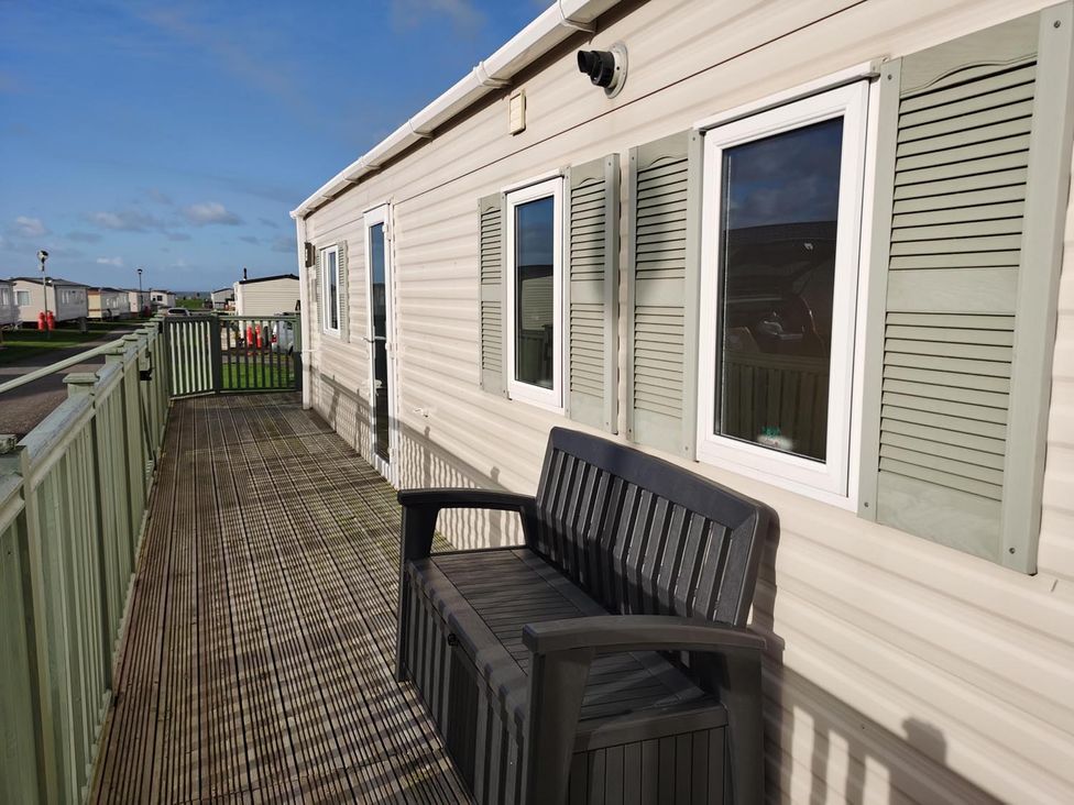 An outdoor area with a bench and windows at Snowdonia Sunbeach Holiday Sea and Mountain view, Llwyngwril