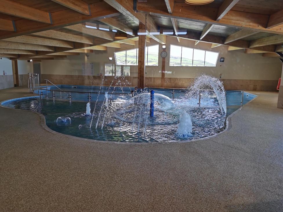An indoor pool with water features at Snowdonia Sunbeach Holiday Sea and Mountain view in Llwyngwril