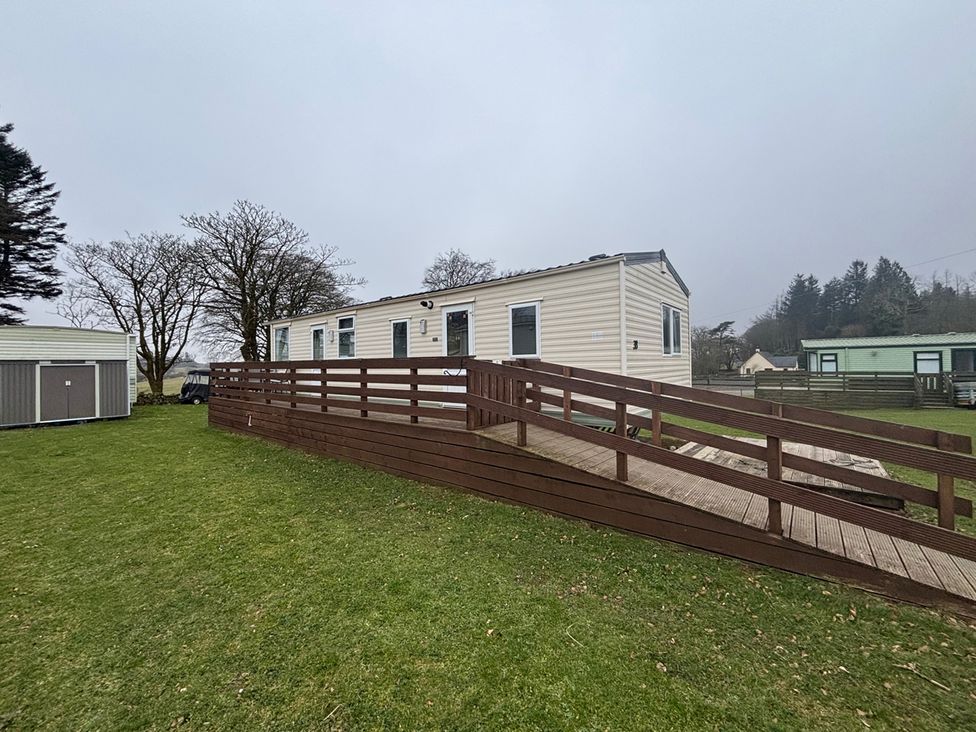 A mobile home with a ramp and decking at No 38 Heilan Hoose at Three Lochs Newton Stewart