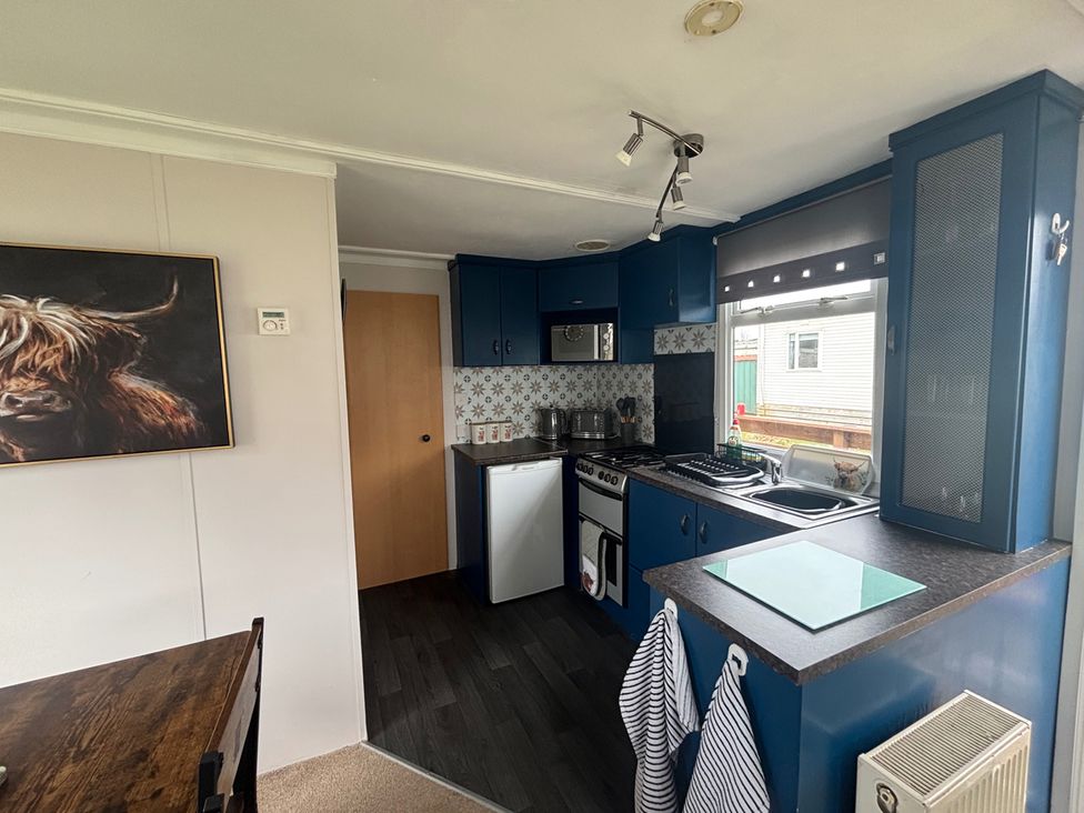 A kitchen with appliances and cabinetry at No 38 Heilan Hoose at Three Lochs Newton Stewart