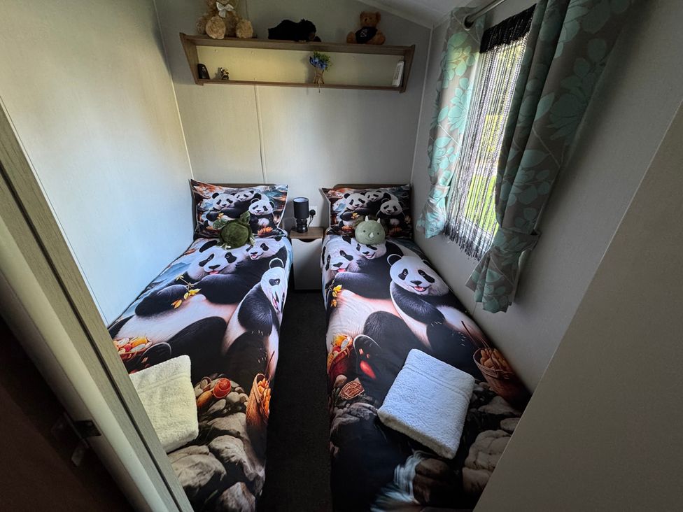 A bedroom with two beds and panda themed bedding at Wl34 Caravan Haggerston Castle Private Decking in Haggerston