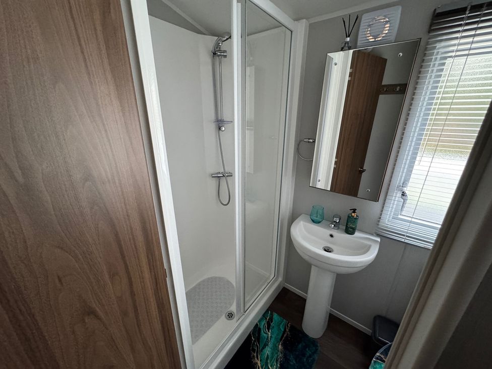 A bathroom with shower and sink at Wl34 Caravan Haggerston Castle Private Decking Haggerston