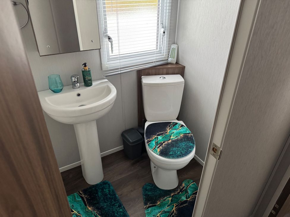 A bathroom with a wash basin and toilet at Wl34 Caravan Haggerston Castle Private Decking in Haggerston