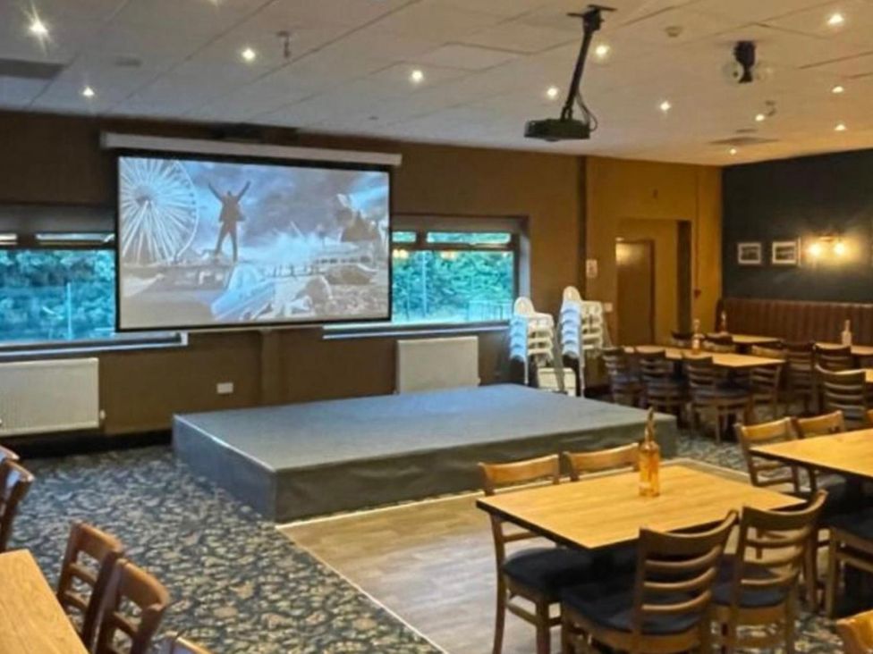 A function room with tables and chairs at Pet Friendly 2-Bed Lodge, Sleeps 5, Pool & Parking in Caernarfon
