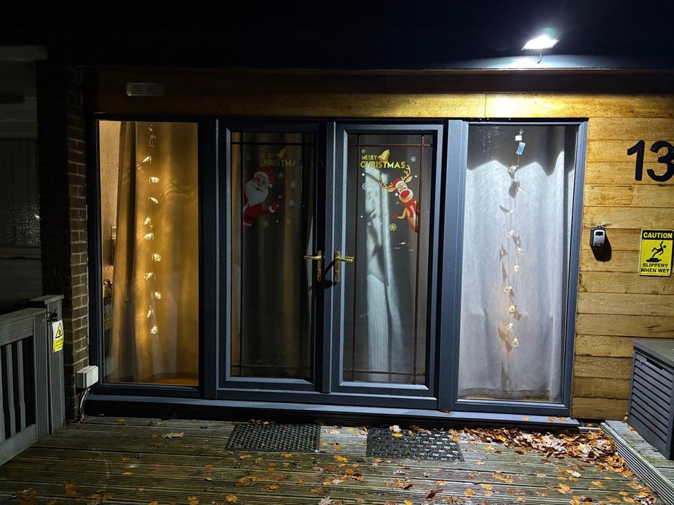 An entrance with decorated doors and lights at Pet Friendly 2-Bed Lodge, Sleeps 5, Pool & Parking, Caernarfon