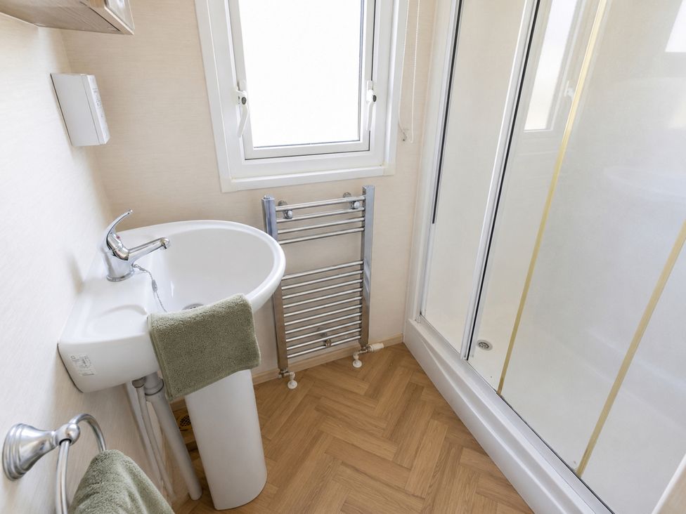 A bathroom with a sink and shower at Caravan - Sleeps 8 - Parking, Northampton