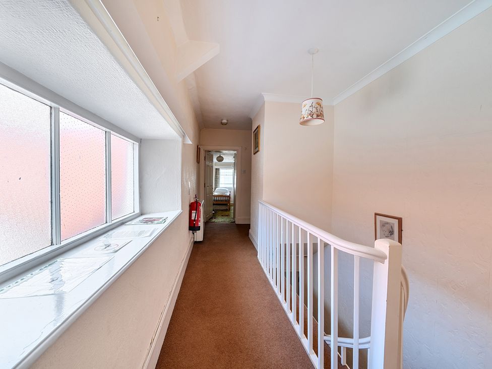 A hallway with a window and a fire extinguisher at House in historic village - Sleeps 6, Dunster
