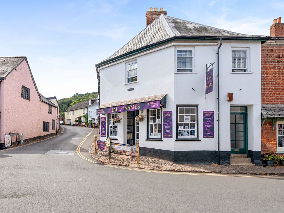 A shop called Hall of Names on a street corner in Dunster