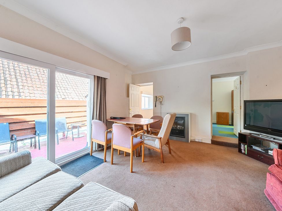 A living room with a dining table and sofa at House in historic village - Sleeps 6 Dunster