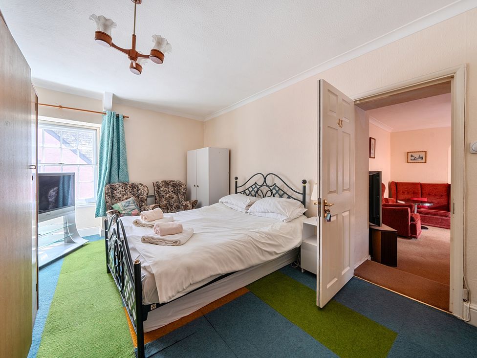 A bedroom with a bed and wardrobe at House in historic village - Sleeps 6 Dunster