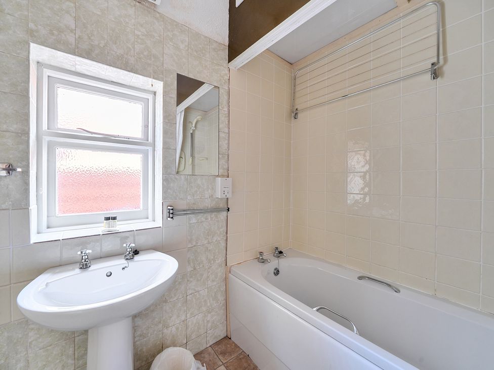 A bathroom featuring a sink and bathtub at House in historic village - Sleeps 6 Dunster