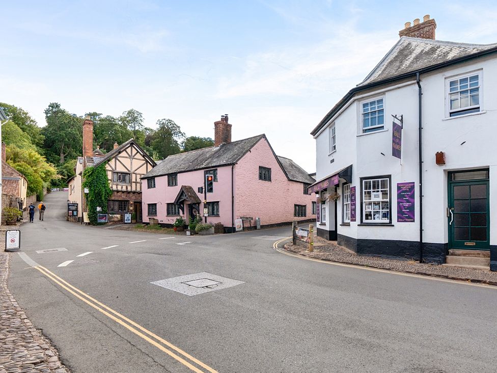 A street view with buildings and people at House in historic village - Sleeps 6, Dunster