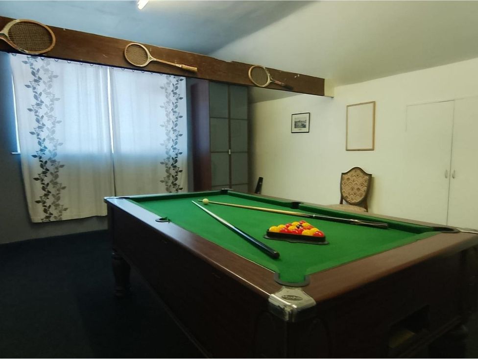 A snug with a pool table and cue sticks at Sharvels Oast House - Pool, Tennis, Luxury Home in Peasmarsh