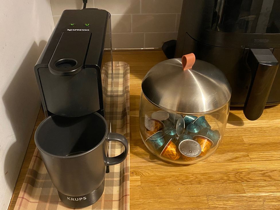A Nespresso machine and coffee capsules in a kitchen at Quiet, Modern Ground Floor Annex Near Theatr Clwyd, Sychdyn