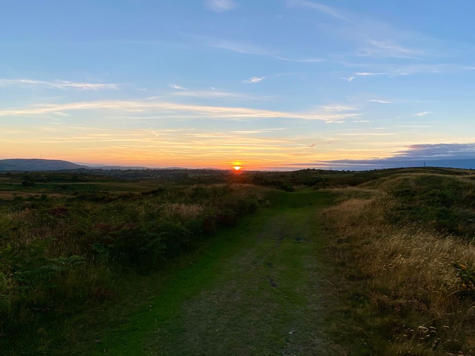 A path at sunset with hills in the background at Quiet, Modern Ground Floor Annex Near Theatr Clwyd, Sychdyn