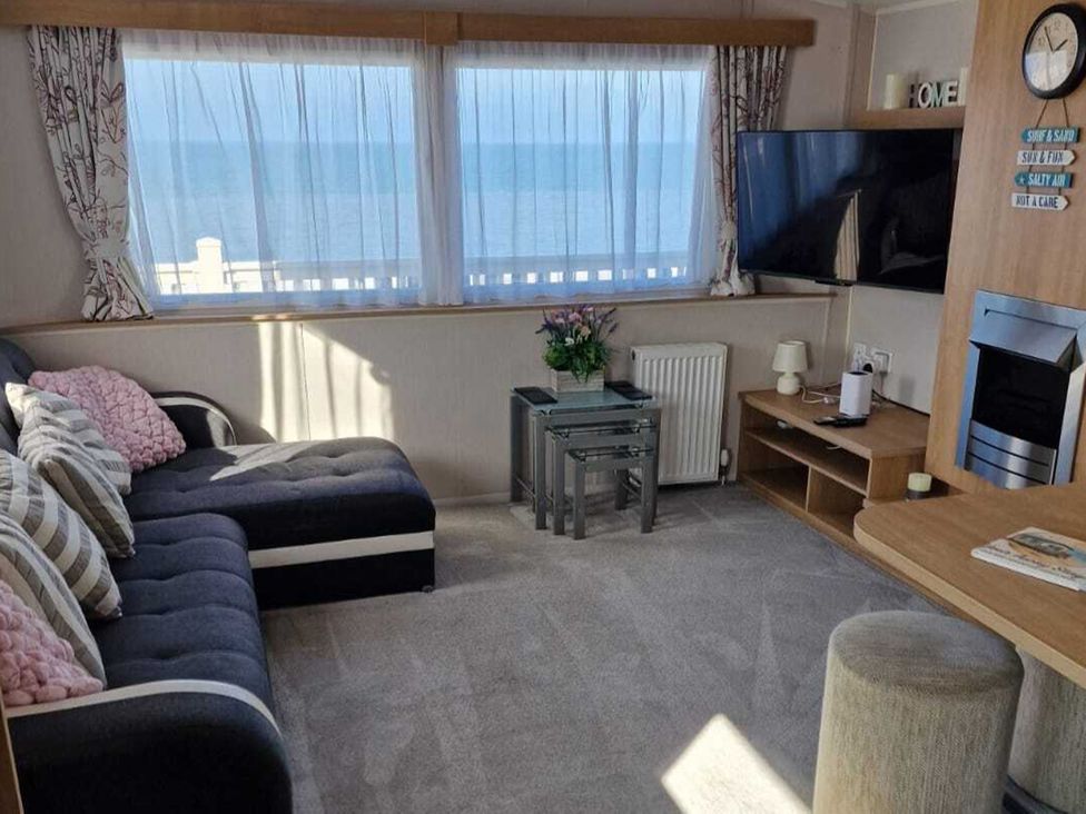 A living room with a sofa, coffee table, and TV at Seafront Caravan - Golden Sands - 6 Berth by Your Away Stays in Kinmel Bay