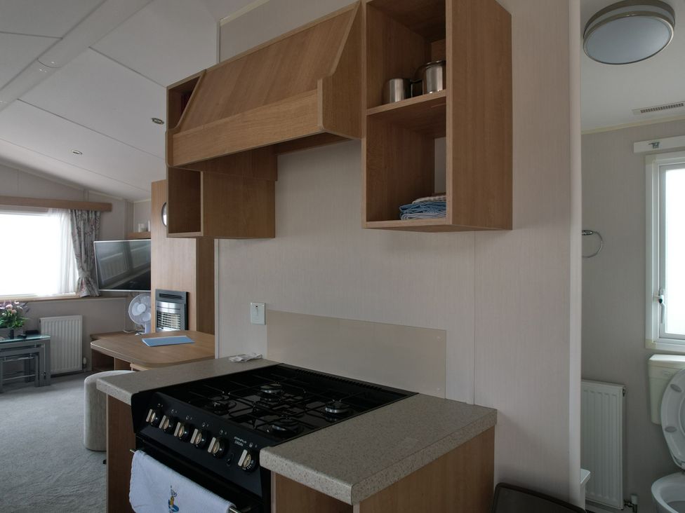 A kitchen with stove and kitchen cabinet at Seafront Caravan - Golden Sands - 6 Berth by Your Away Stays in Kinmel Bay