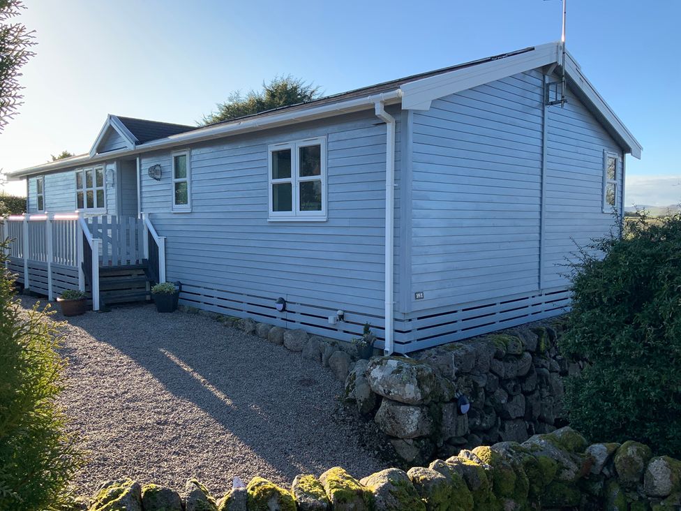 Exterior view of a wooden lodge at Holly Blue - Cosy wooden lodge, Kippford near Dalbeattie