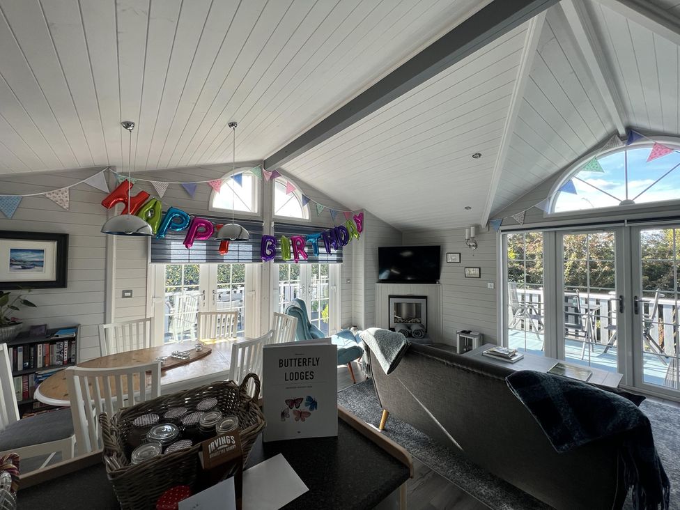 A living room with a birthday decoration at Butterfly Lodges in Kippford Holiday Park near Dalbeattie