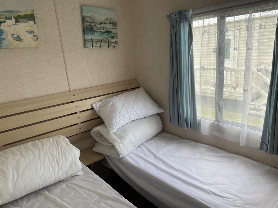 A bedroom with beds and wall art at 4 Bed Lodge Sleeps 8 - Pets & WiFi Free Parking in Ingoldmells