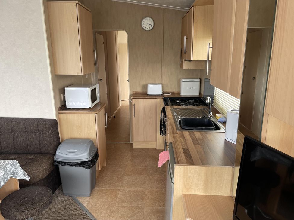 A kitchen with a microwave and stove at 4 Bed Lodge Sleeps 8 - Pets & WiFi Free Parking in Ingoldmells