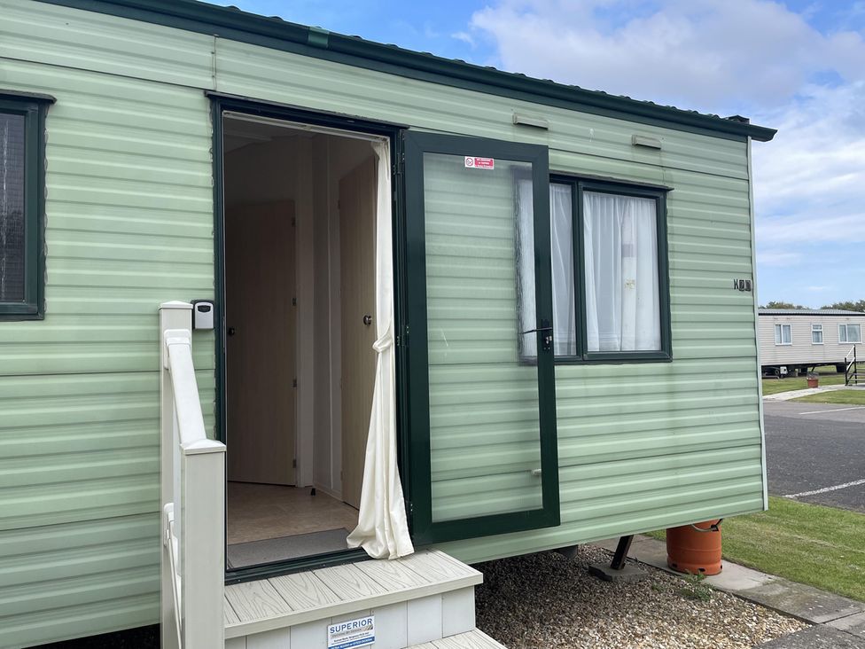 A caravan with steps and an open door at 4 Bed Lodge Sleeps 8 - Pets & WiFi Free Parking in Ingoldmells