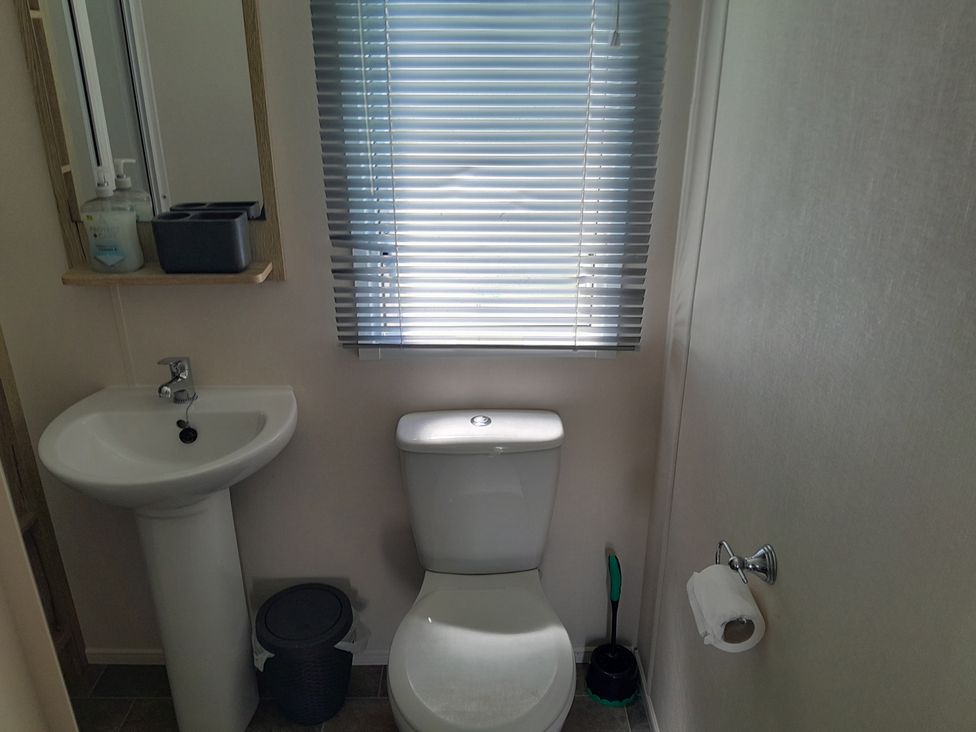 A bathroom with a toilet and sink at Ye Old'e Man - Sleeps 6 & Pet Friendly near Flookburgh