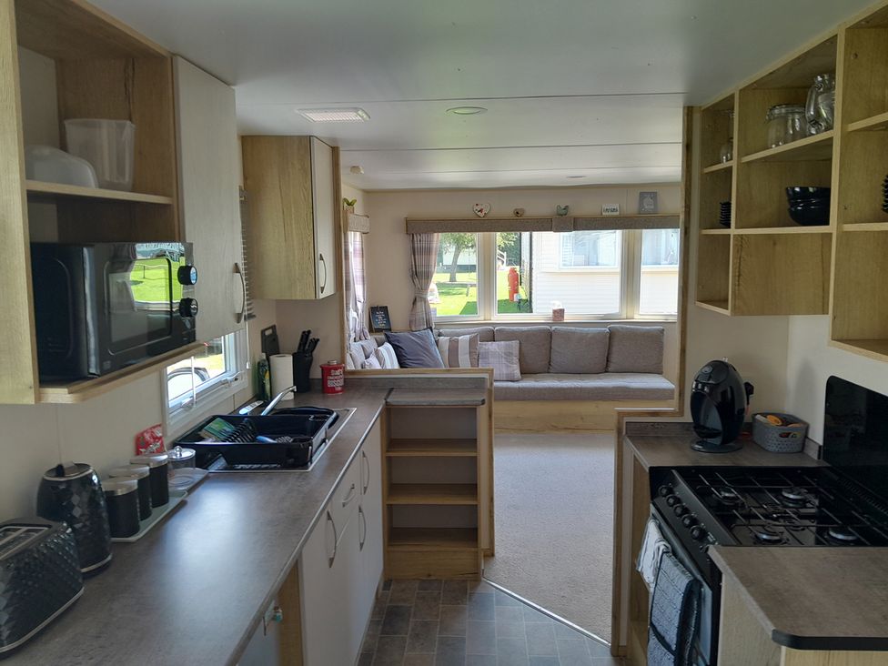 A kitchen with microwave, sink, and oven at Ye Old'e Man - Sleeps 6 & Pet Friendly Near Flookburgh