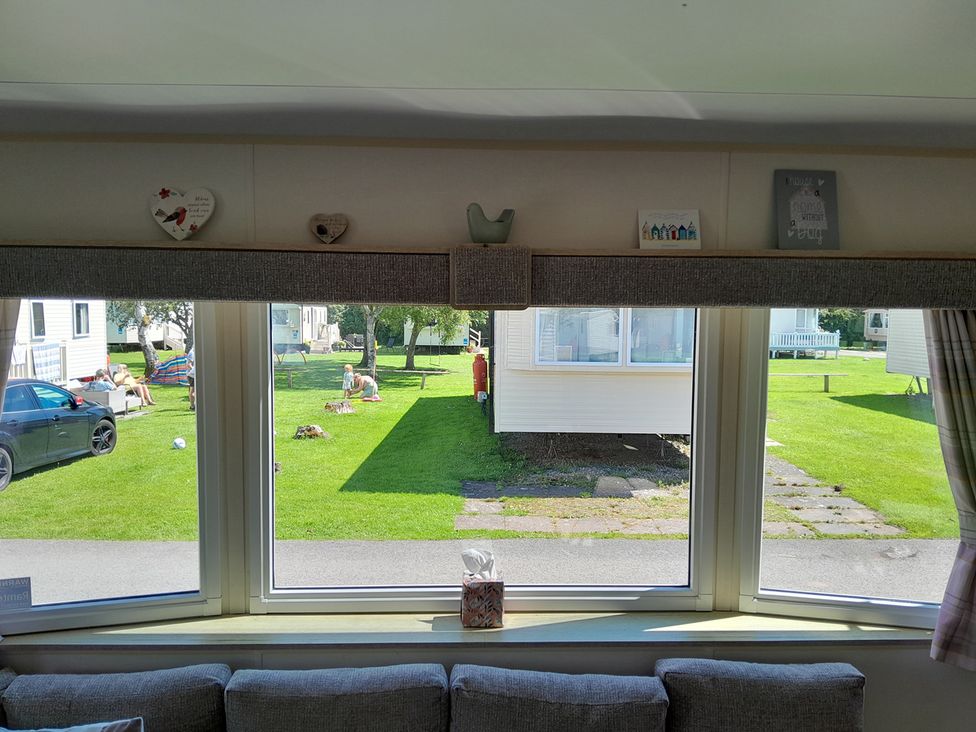 A living room with a view of the garden at Ye Old'e Man - Sleeps 6 & Pet Friendly near Flookburgh