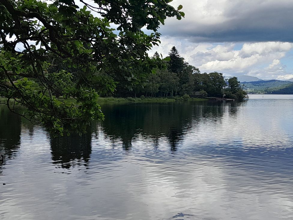 A lake with trees and clouds near Flookburgh