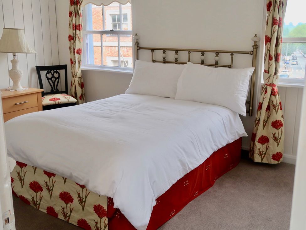 A bedroom with a bed and bedside table at 4BedHouse/Leominster/Hiking/Castles/Sleeps7/Wifi in Leominster