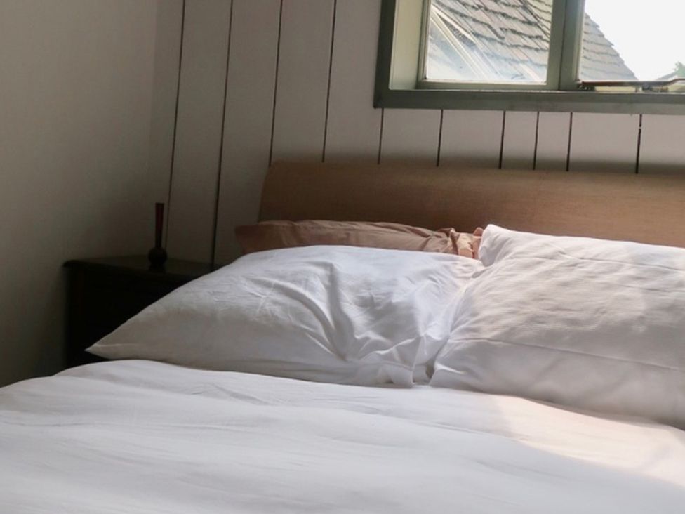 A bedroom with a bed and pillows at 4BedHouse in Leominster