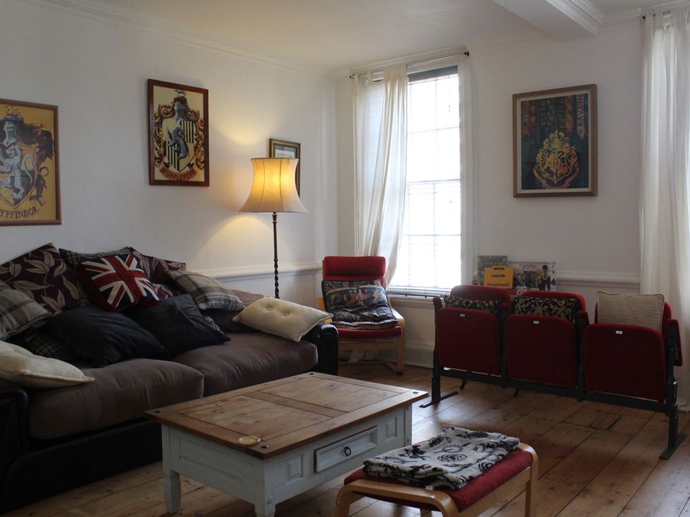 A living room with a sofa and a coffee table at 4BedHouse in Leominster