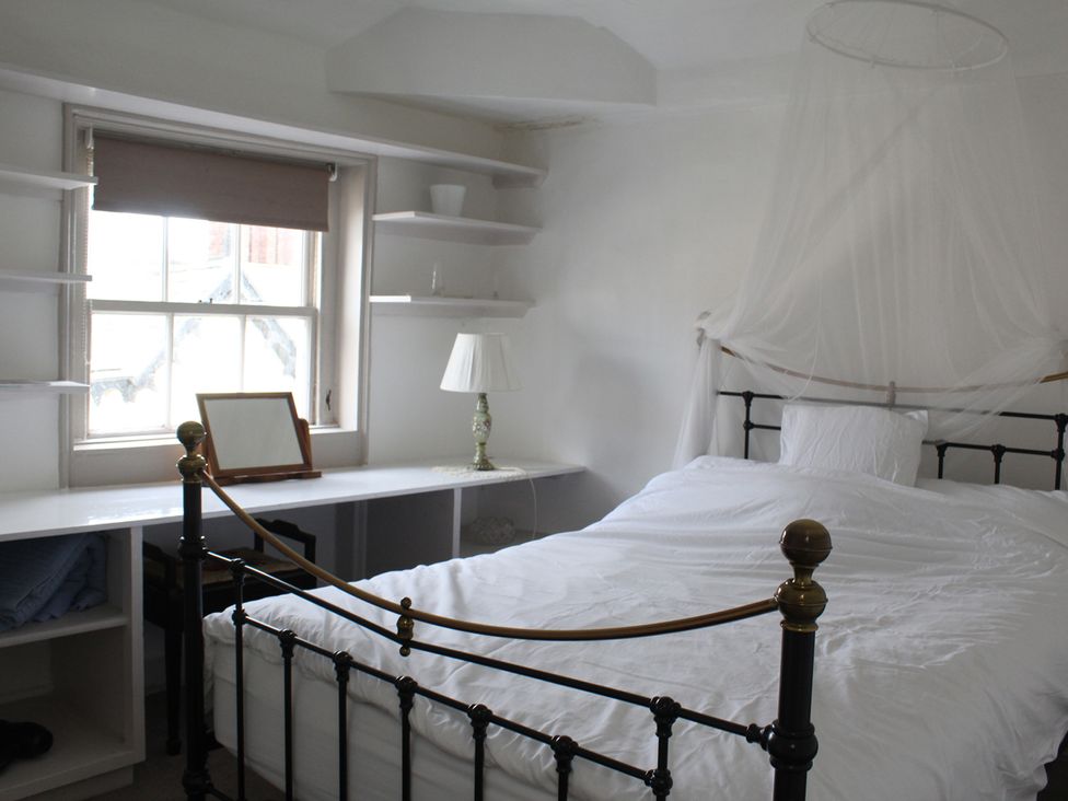 A bedroom with a bed and shelves at 4BedHouse/Leominster/Hiking/Castles/Sleeps7/Wifi in Leominster
