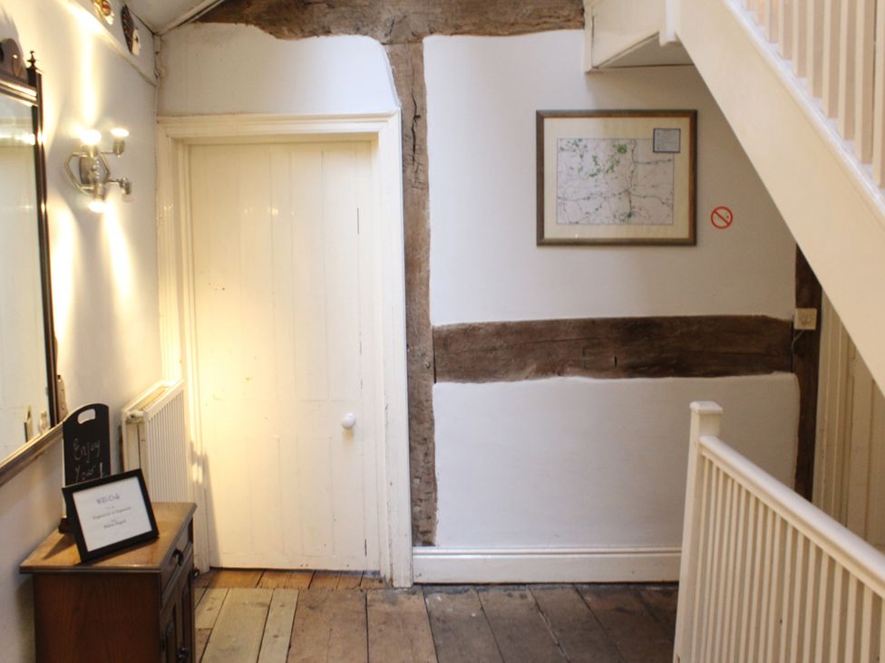 A hallway with a mirror and door at 4BedHouse/Leominster/Hiking/Castles/Sleeps7/Wifi, Leominster
